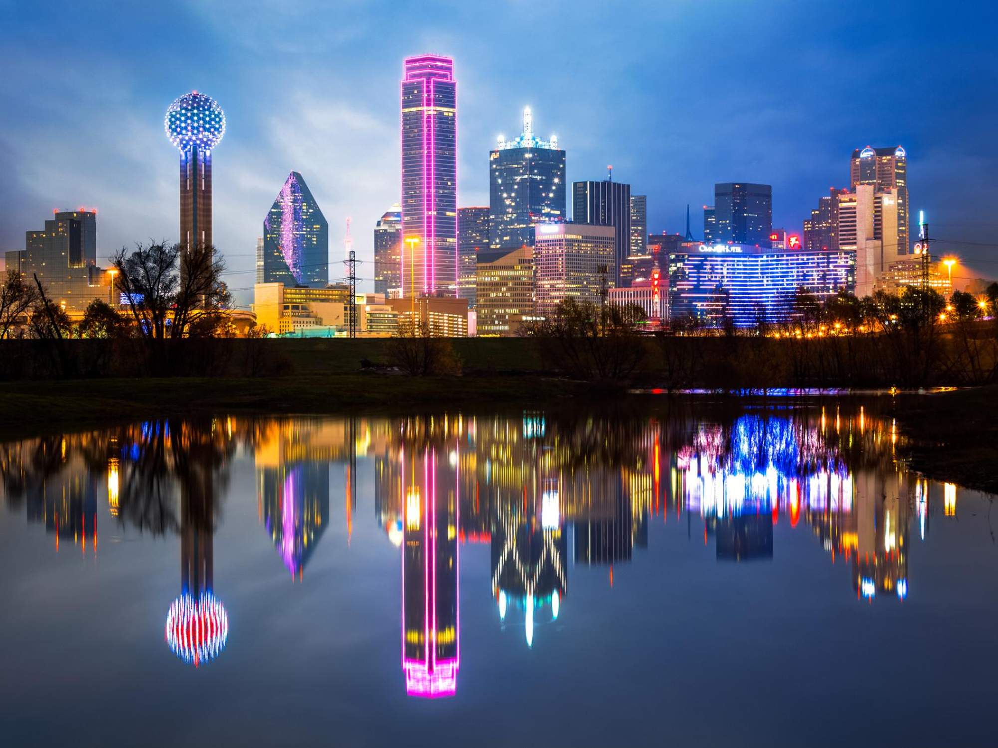 Dallas skyline reflected in water at dusk